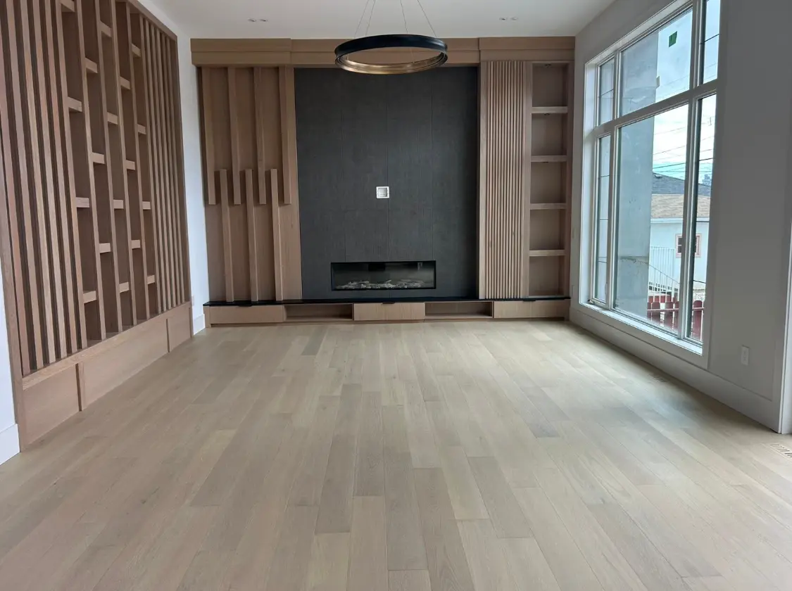 Unfurnished luxury living room with wood slat feature wall and fireplace before home staging